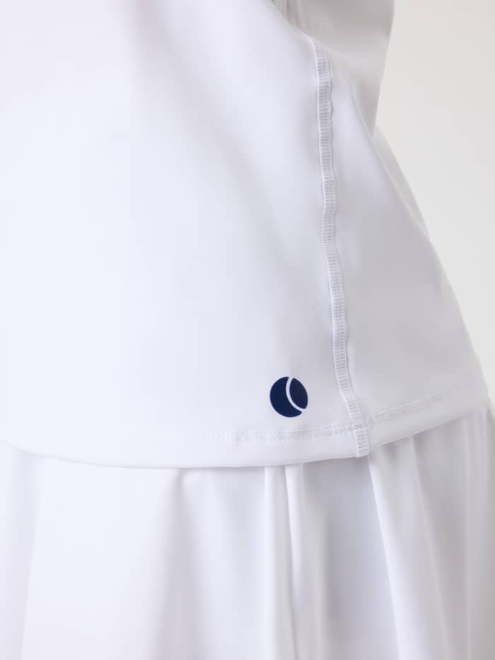 Close-up of the kids Ace Racerback Tank Top in Brilliant White (White), featuring the navy tennis ball logo on the hem. - Image 5