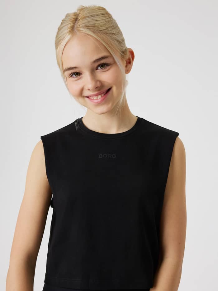 Front view of a girl wearing the Black Beauty (Black) Borg Cropped Tank Top for kids, a soft training top with a black logo.