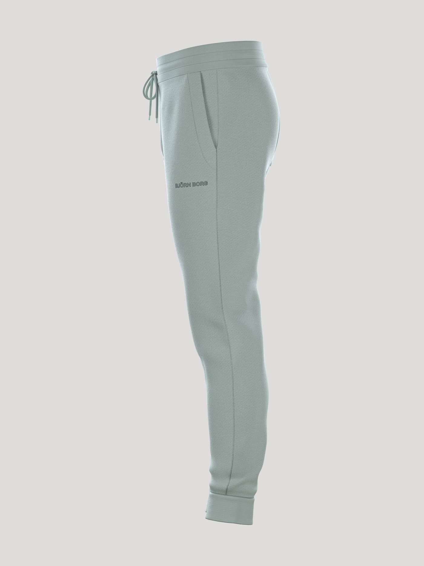 Borg Essential 3 Tapered Sweatpants i Slate Gray (Grøn) set fra siden med et mørkt logo for en skarp tennisstil. - Image 4