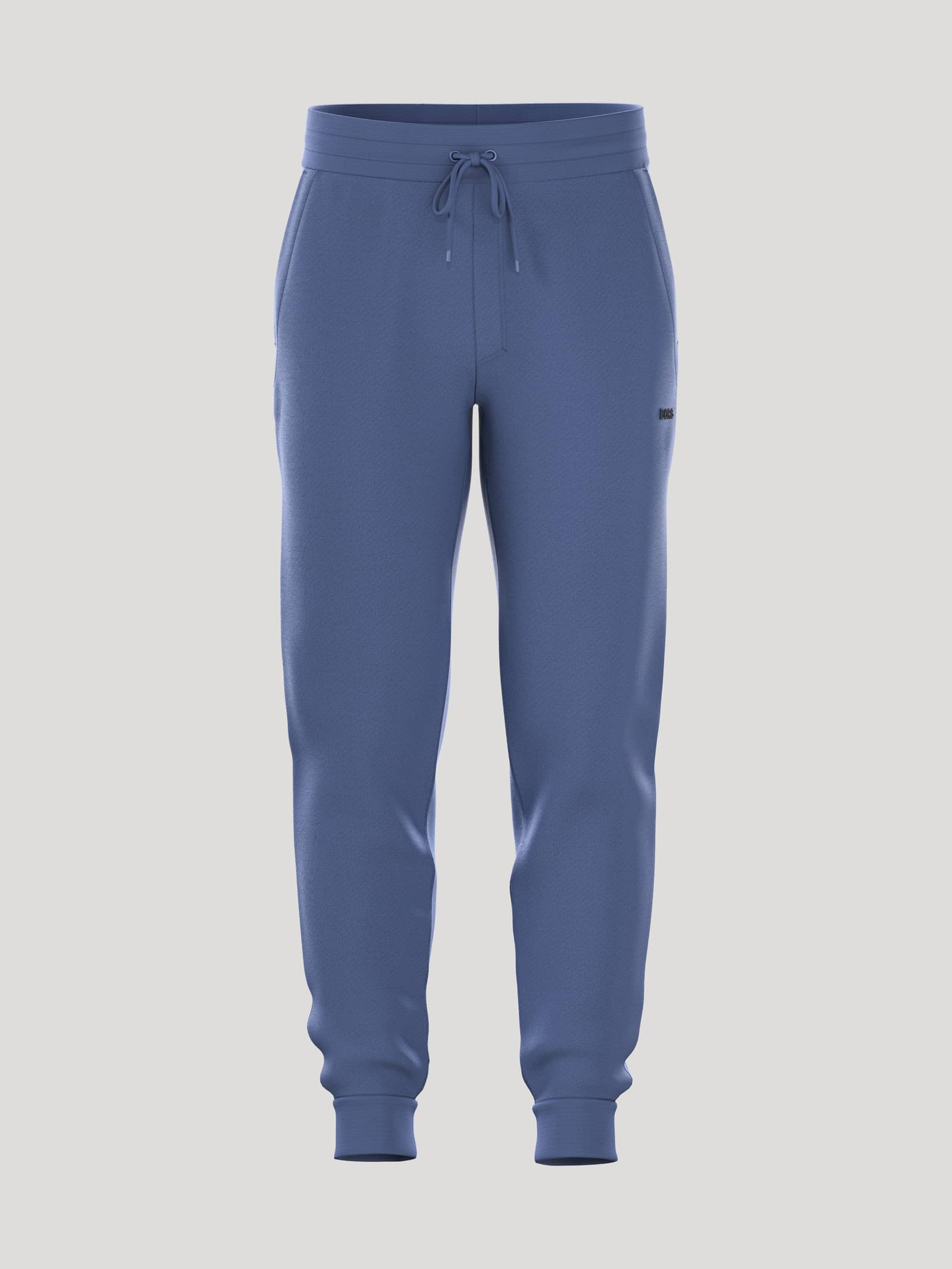 Borg Essential 4 Tapered Sweatpants sedda framifrån i Coastal Fjord (Blå) med svart logotypbrodyr. - Image 1