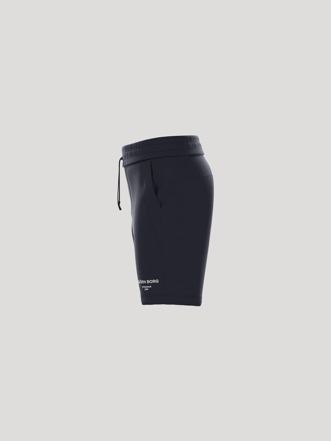 Side profile of the Borg Essential 1 Sweatshorts for kids in Night Sky (Navy) with a white logo and regular fit. - Image 4