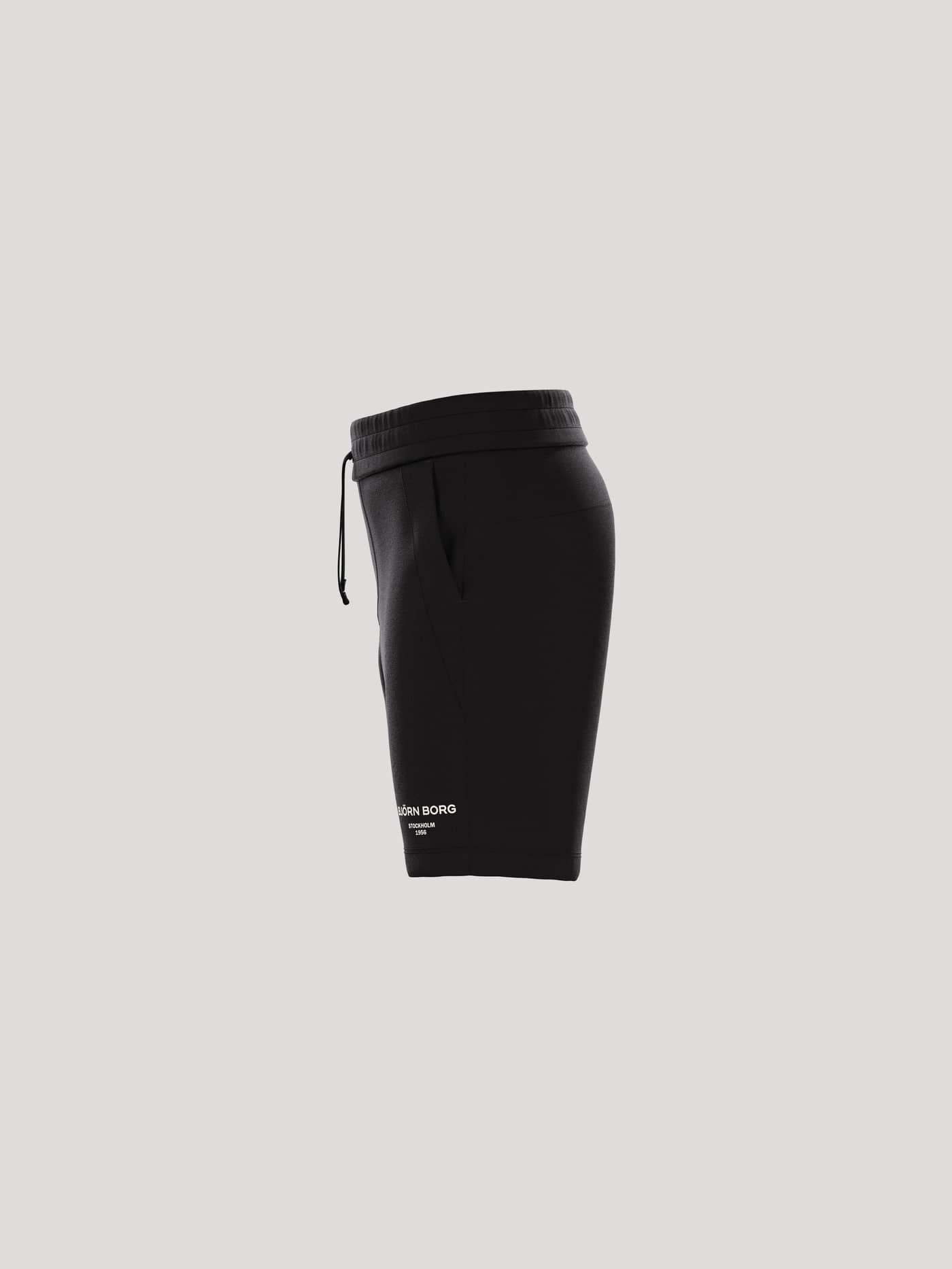Zijaanzicht van de Borg Essential 1 Sweatshorts voor kids in Black Beauty (Zwart) met een wit logo en een relaxte fit. - Image 4