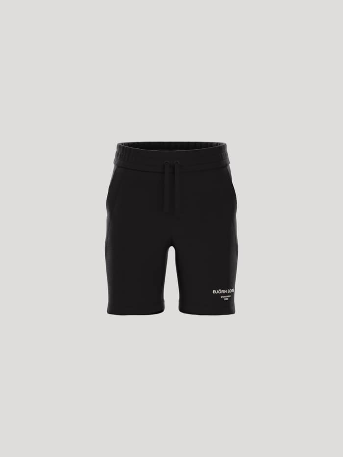 Framifrån på Borg Essential 1 Sweatshorts för kids i Black Beauty (Svart), bomullsblandning med vit logotyp.