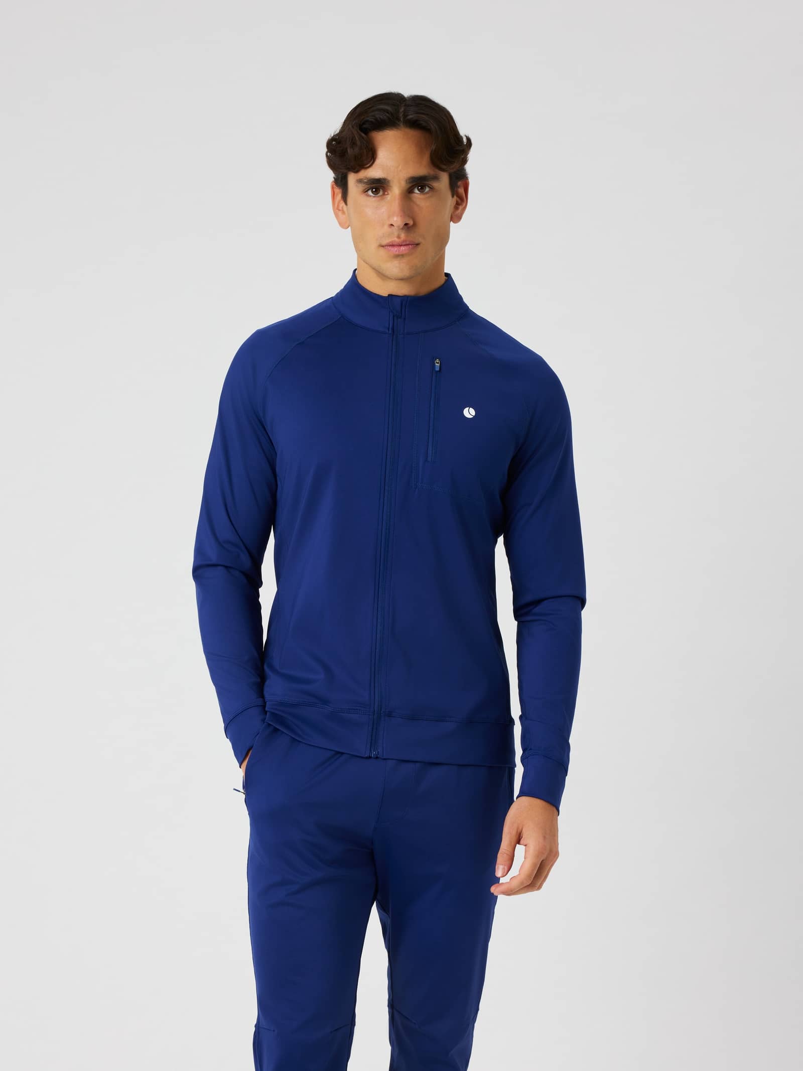 Front view of a man wearing the Björn Borg Ace Training Jacket in Blue Depths (Blue) for tennis training. - Image 1