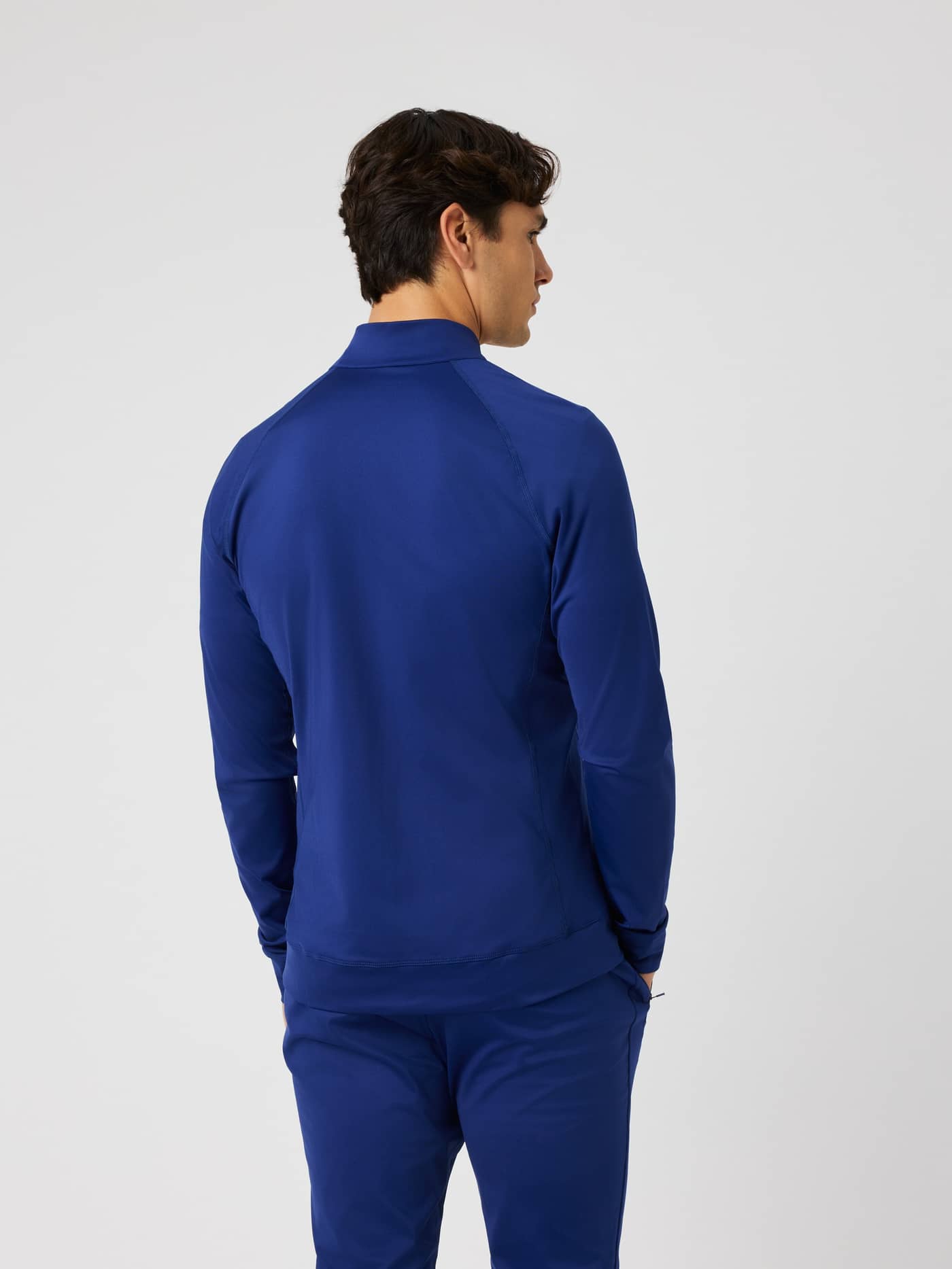 Back view of a man wearing the Björn Borg Ace Training Jacket in Blue Depths (Blue) for tennis training. - Image 2