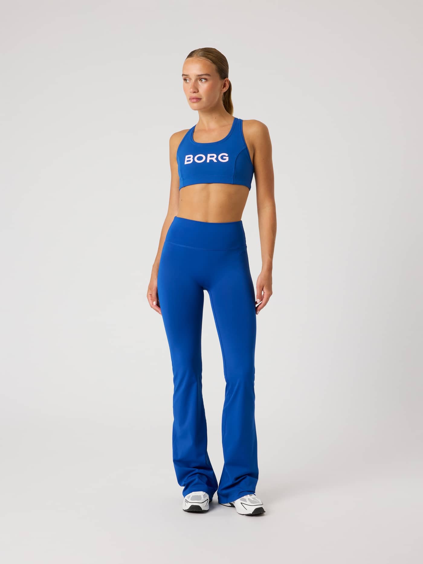 Full-body front view of a model in Monaco Blue (Blue) Borg Flare Tights Regular, offering a stylish fit for training. - Image 3
