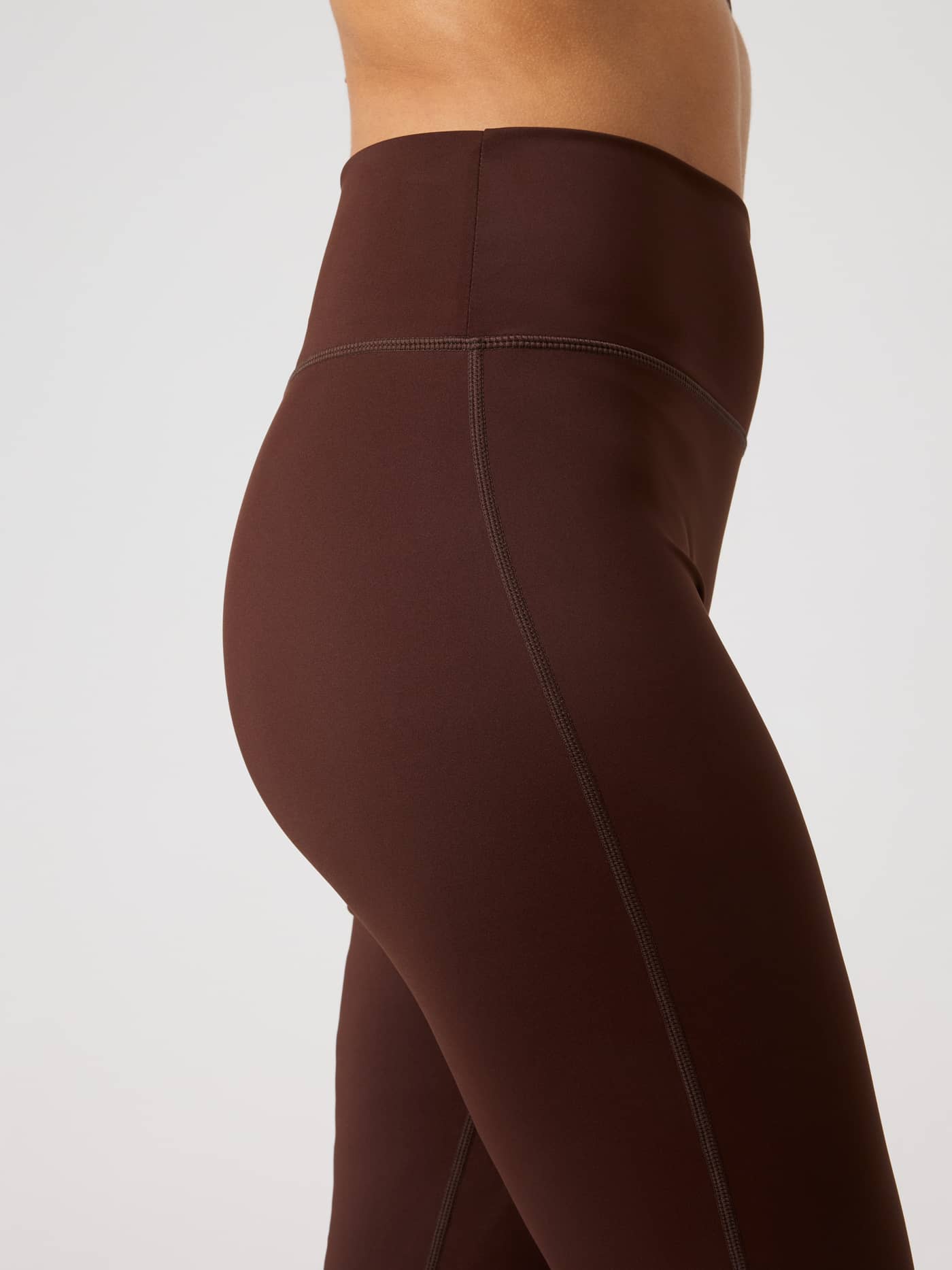 Side-profile view of the Borg Flare Tights Regular in Coffee Bean (Brown) with a high waist and sleek training silhouette. - Image 5