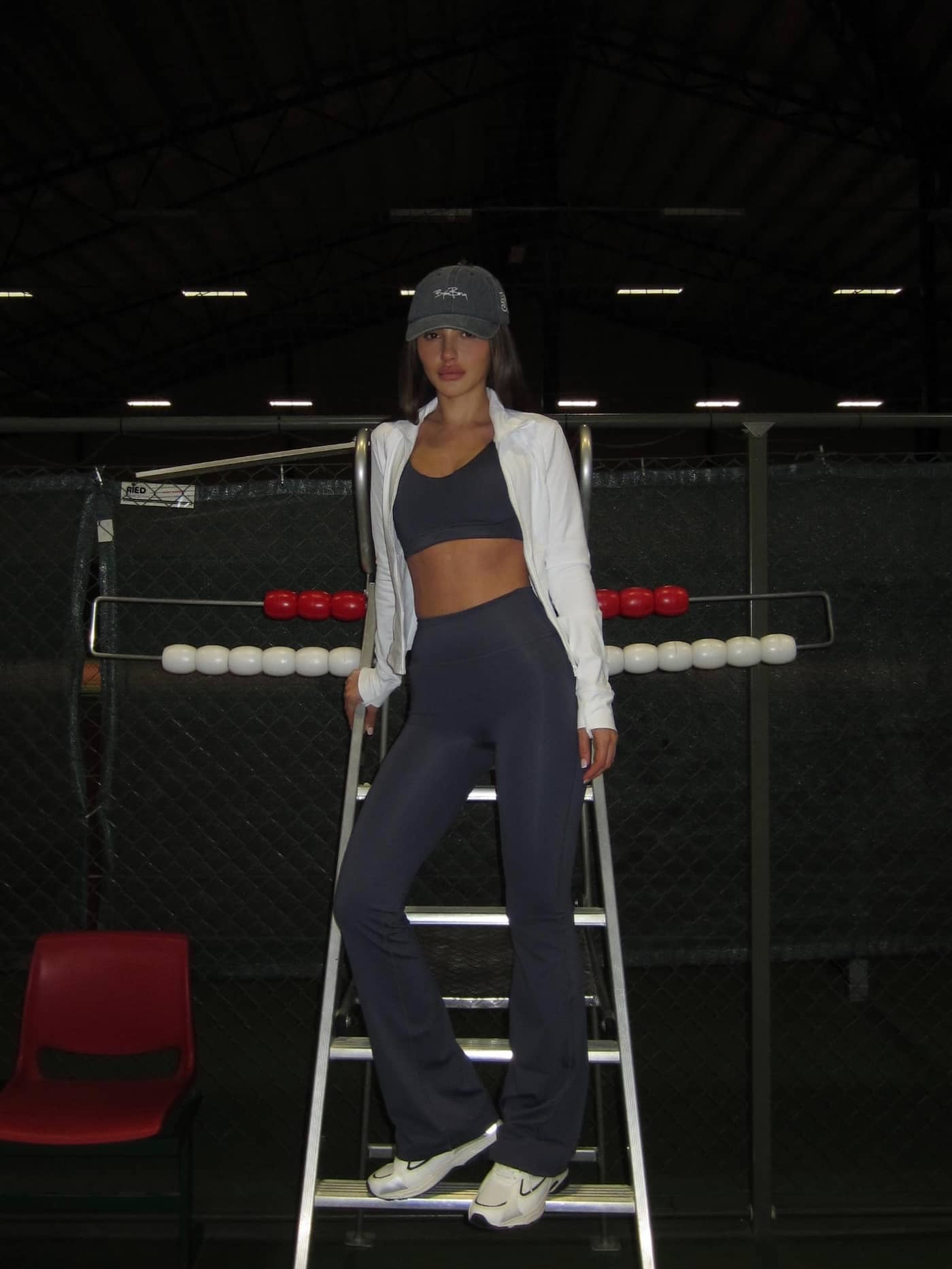 Full-body view of a woman wearing Borg Flare Tights Regular in Odyssey Gray (Navy) for a stylish flared training fit. - Image 3