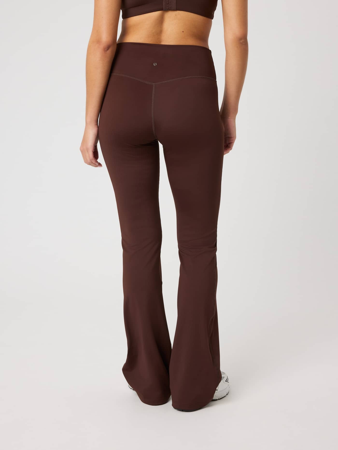 Back view of the Borg Flare Tights Petite in Coffee Bean (Brown), featuring a high-waisted flared training design. - Image 2