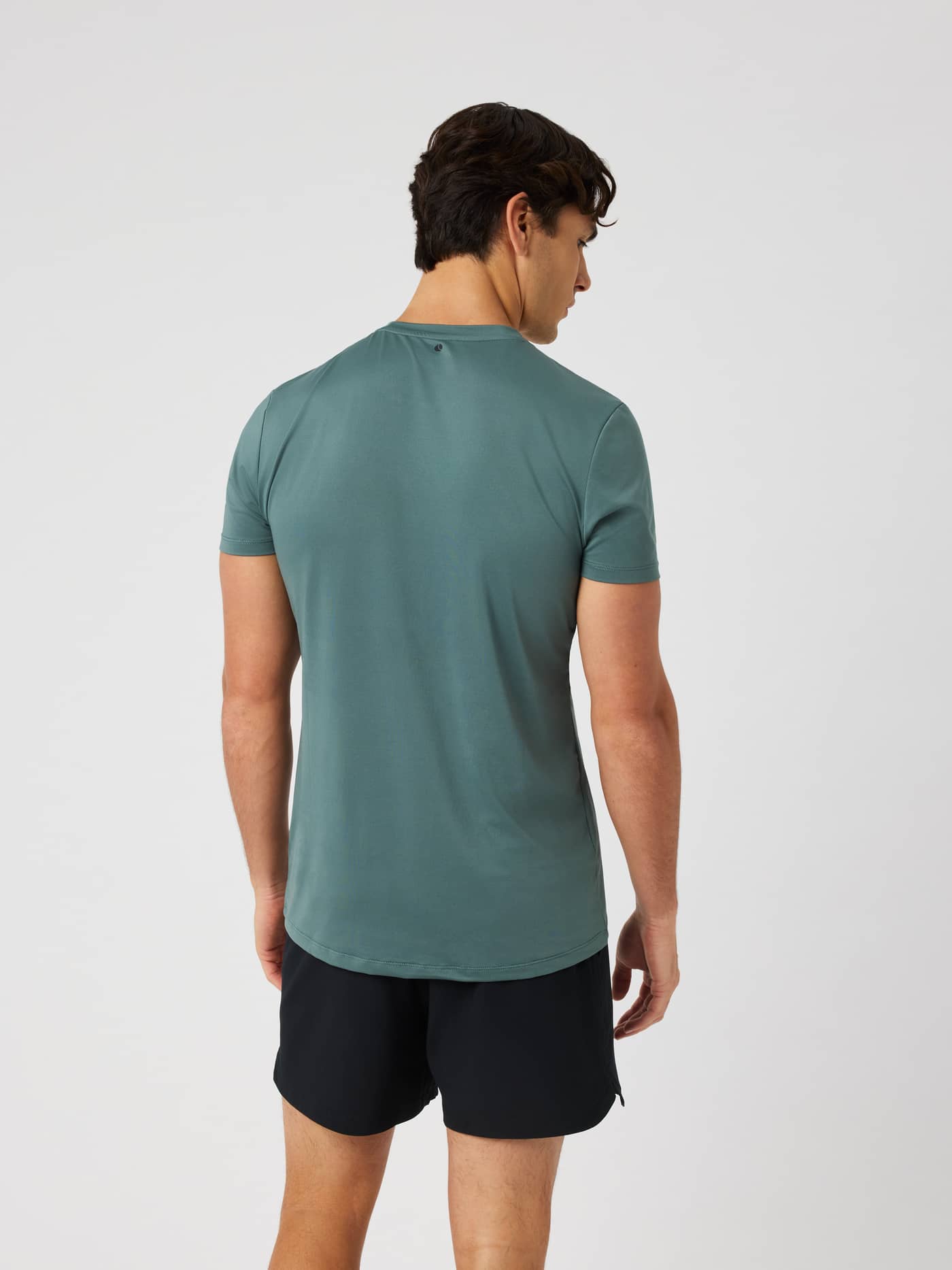 Back view of a man in the stylish and functional Balsam Green (Green) Borg Graphic T-Shirt for training and tennis. - Image 3