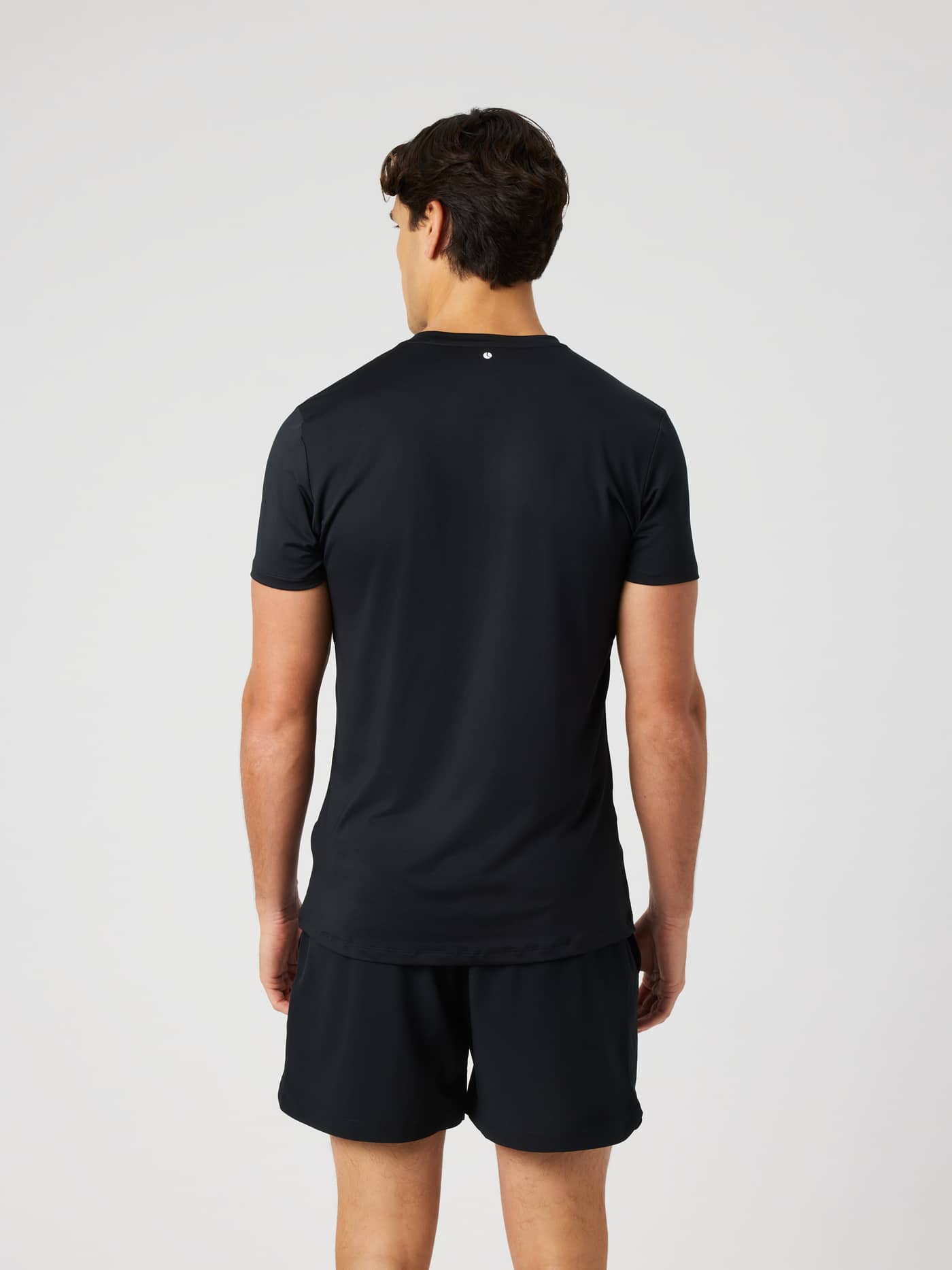 Back view of a man wearing the functional Borg Graphic T-Shirt in Black Beauty (Black), perfect for training and tennis. - Image 2