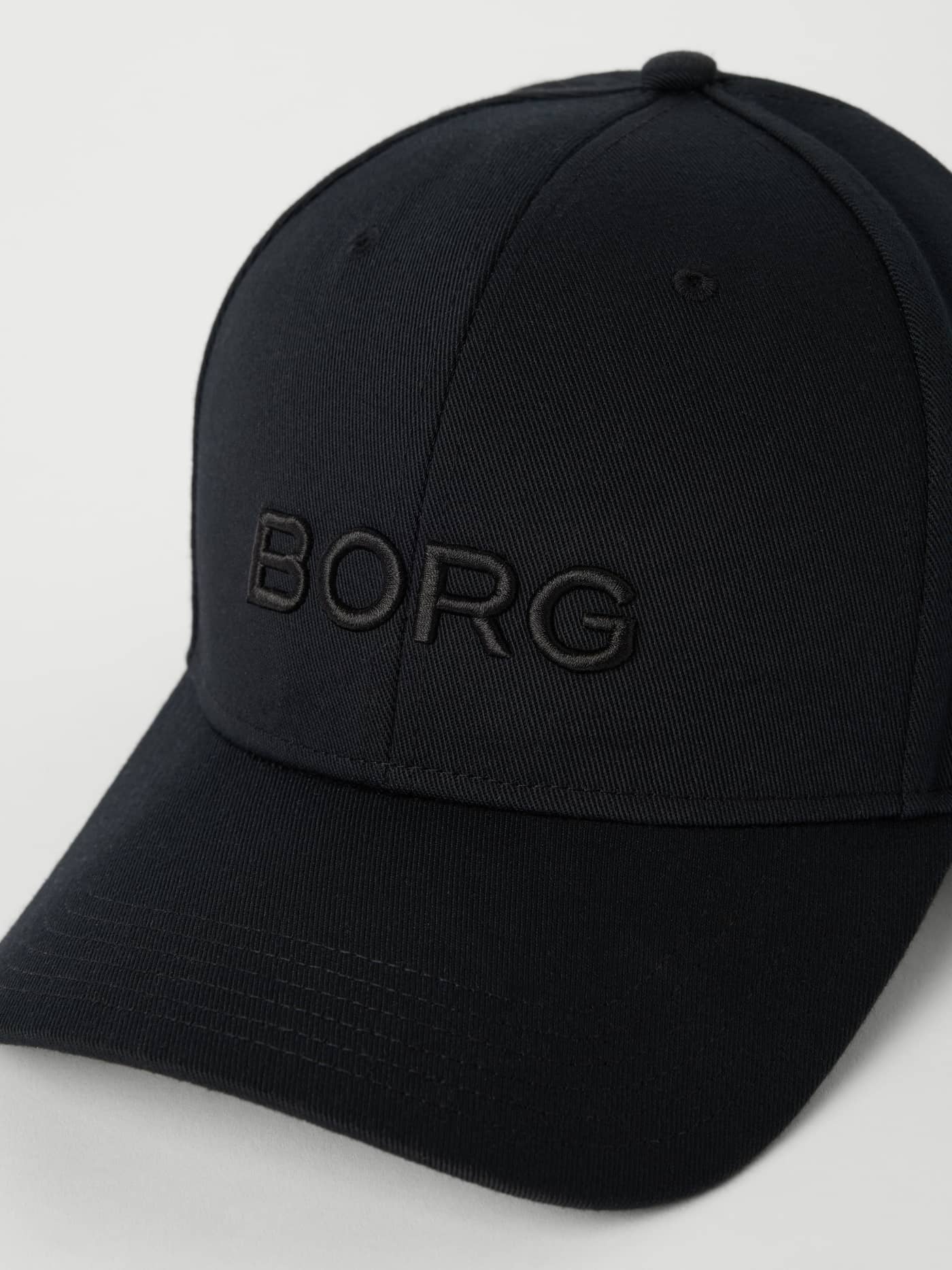 Detailed close-up of the Borg Baseball Cap in Black Beauty (Black), showcasing the tonal embossed logo on the front. - Image 2