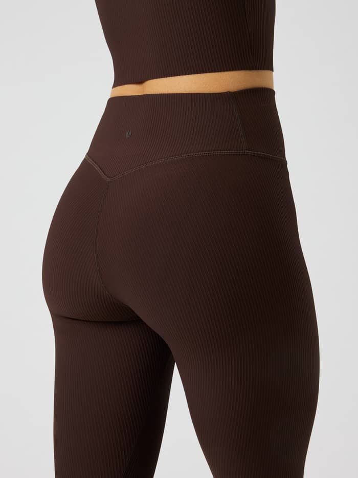 Achteraanzicht van de Studio Ribbed Tights in Coffee Bean (Bruin) met een geribbelde textuur en zwart logo voor training. - Image 4
