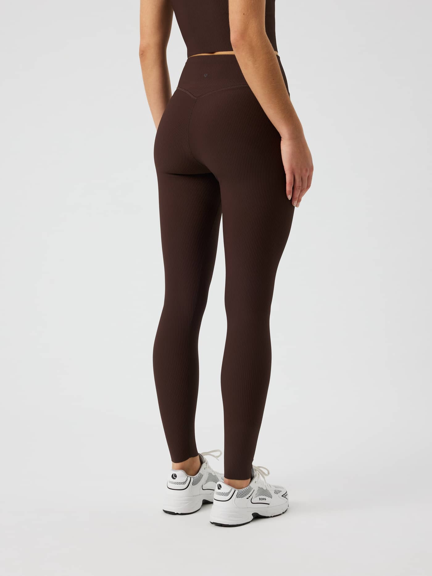 Back view of Studio Ribbed Tights in Coffee Bean (Brown) with a high-waist fit and ribbed texture for training. - Image 3