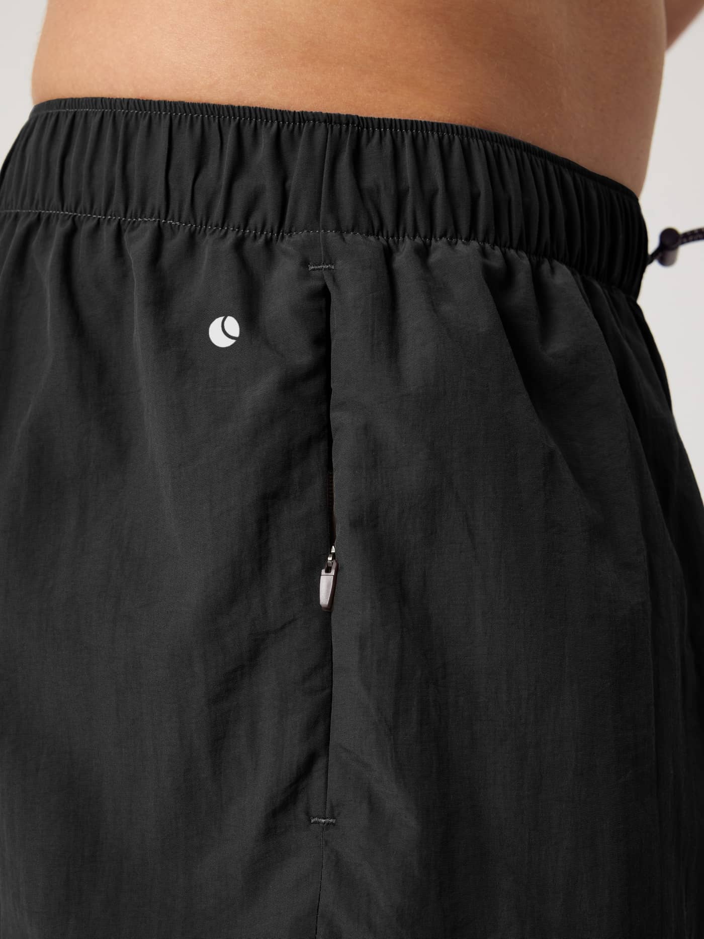 Detailed close-up of the Black Beauty (Black) Borg Gym Shorts 5 Inch for training, showing the zip pocket and white logo. - Image 3