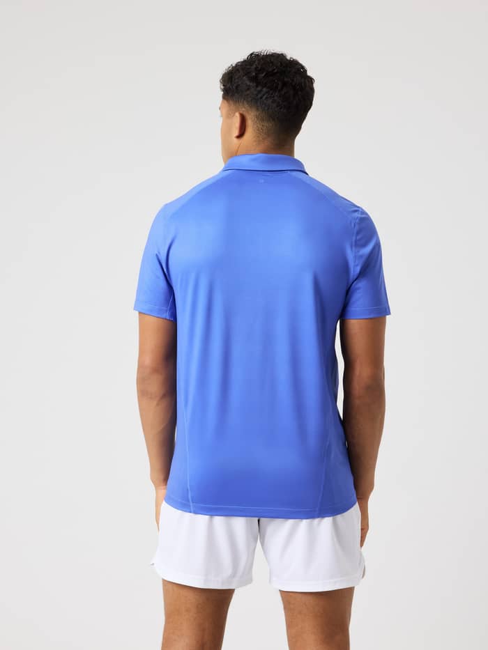 Back view of a man wearing the Amparo Blue (Blue) Borg Sports Polo Shirt, designed for tennis and training performance. - Image 2