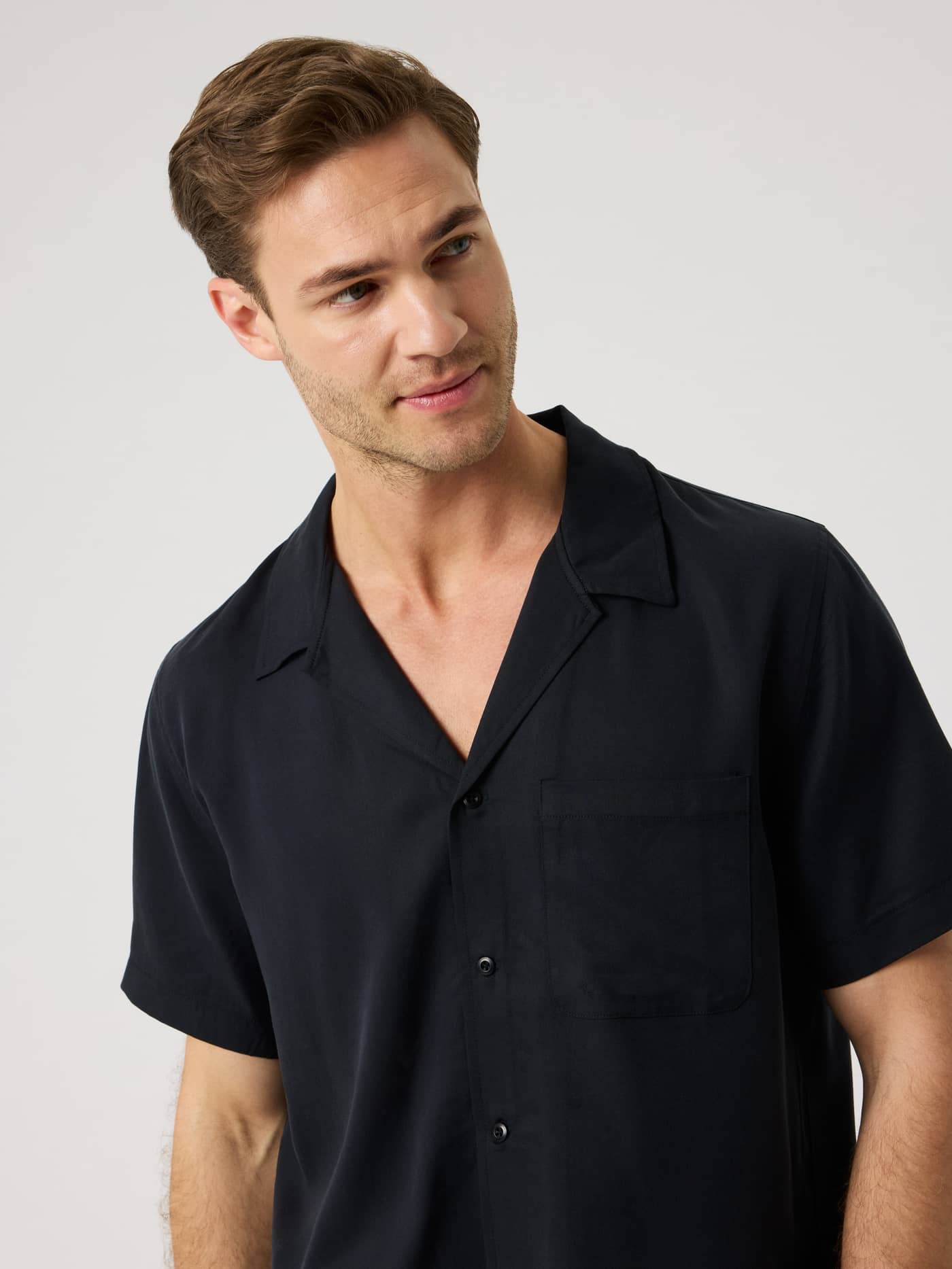 Front view of a man wearing the Björn Borg Lyocell Resort Shirt in Black Beauty (Black) with a camp collar and regular fit. - Image 4