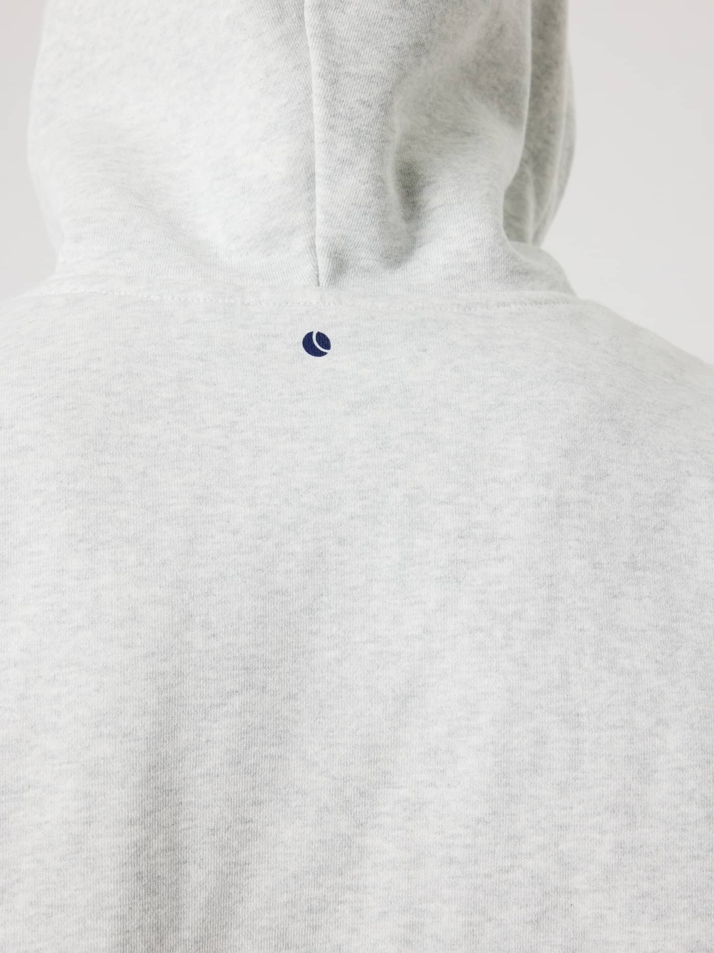 Close-up back view of the Borg Oversized Hoodie in Ultra Light Grey Melange (Grey) with a navy tennis ball print. - Image 9