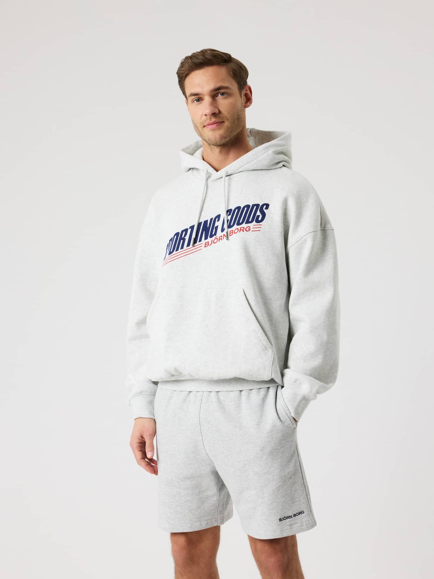 Front view of a man wearing the Borg Oversized Hoodie in Ultra Light Grey Melange (Grey) featuring a relaxed, stylish fit. - Image 3