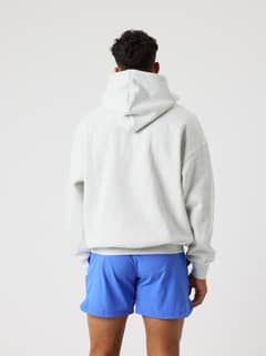 Back view of a man wearing the Björn Borg Oversized Hoodie in Ultra Light Grey Melange (Grey) for style, fit and function. - Image 4