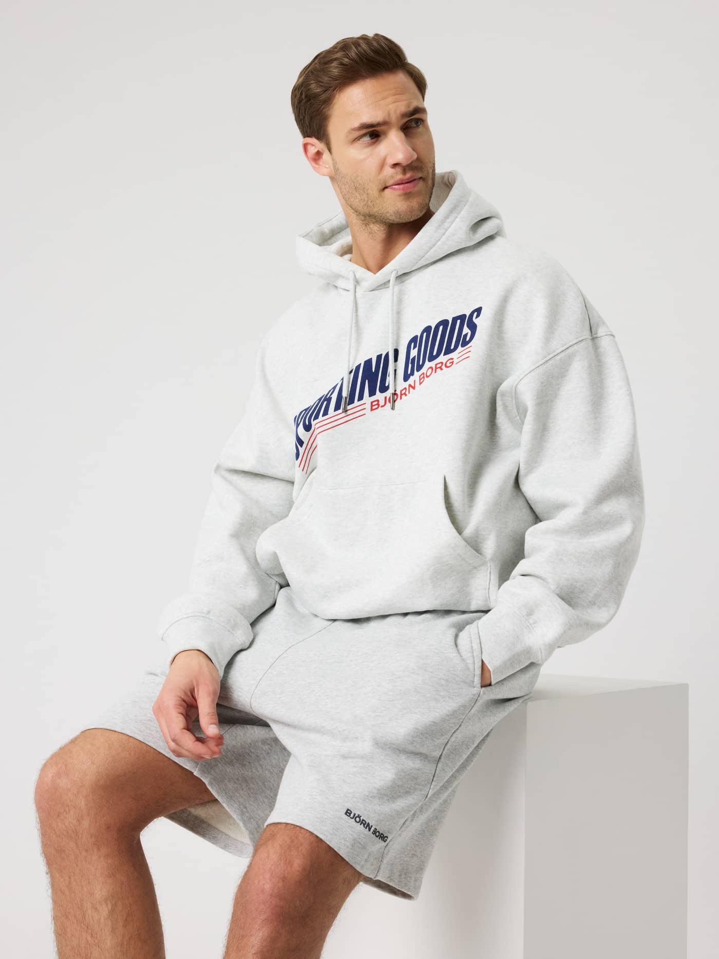 Borg Oversized Hoodie in Ultra Light Grey Melange (Grey) for men with a chest graphic and functional kangaroo pocket. - Image 1