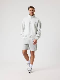 Vorderansicht eines Mannes im Borg Oversized Half-Zip in Ultra Light Grey Melange (Grau) für Training mit schwarzem Logo. - Image 4