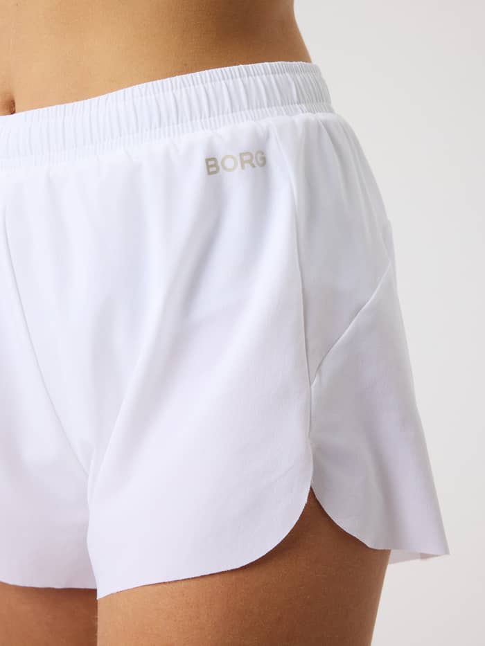 Close-up of the women's Borg Performance 2 In 1 Shorts in Brilliant White (White) for running with a silver reflective logo. - Image 5