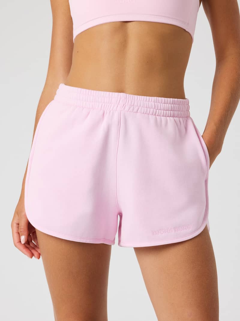 Front view of a model wearing the Björn Borg Sweatshorts in Pink Lady (Pink), highlighting the stylish regular fit.