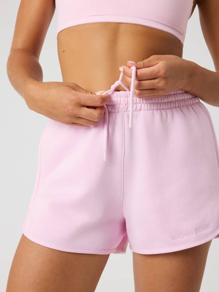 Close-up front view of a model wearing Pink Lady (Pink) Borg Sweatshorts, featuring an adjustable drawstring waist. - Image 5