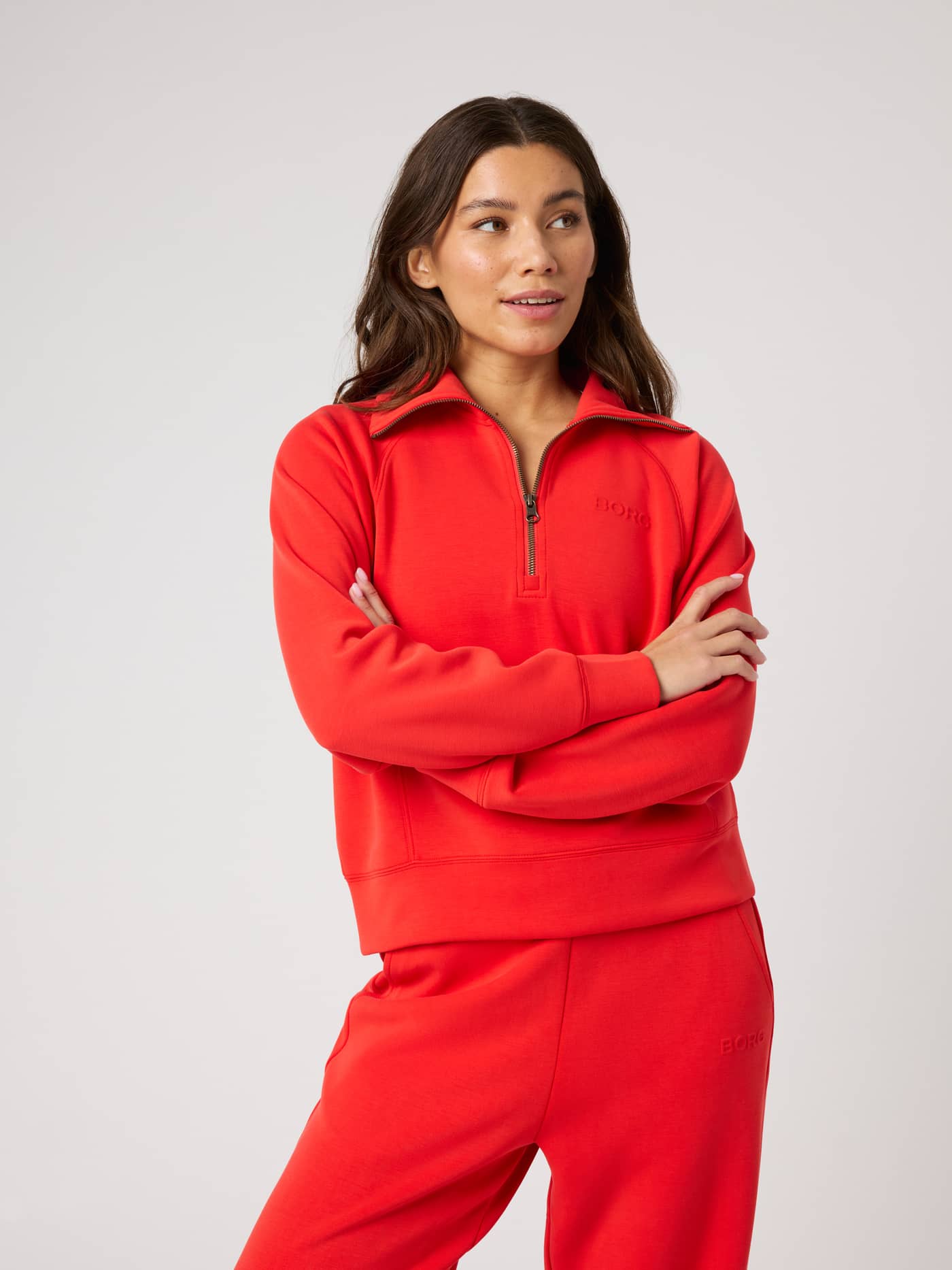 Front view of a model in the Studio Soft Halfzip Sweatshirt in Flame Scarlet (Red) with a high collar and tonal logo. - Image 3