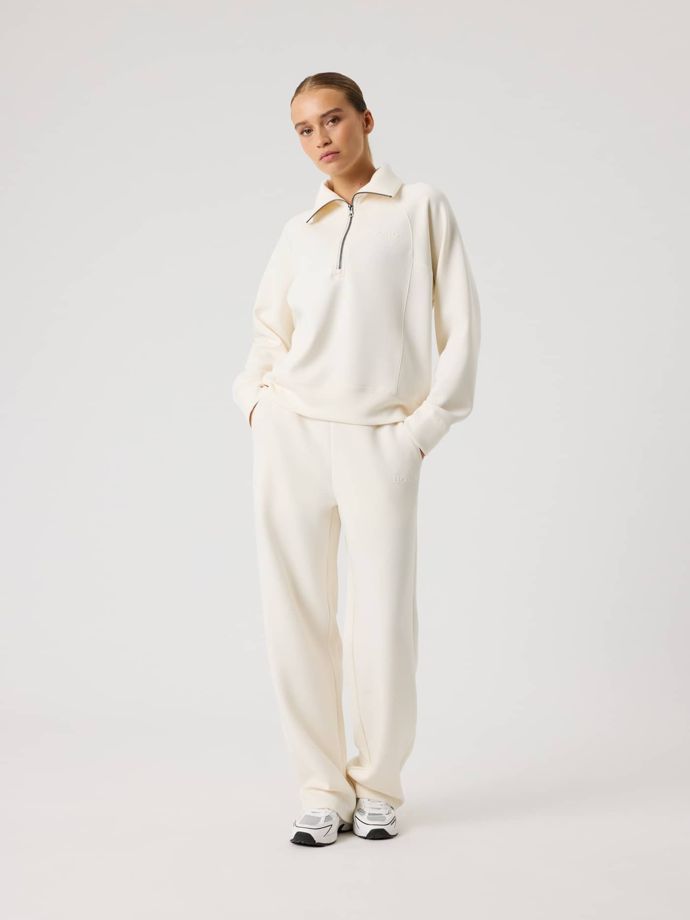 Full-body front view of a model wearing the loose fit Studio Soft Halfzip Sweatshirt in Tofu (White) for women. - Image 6