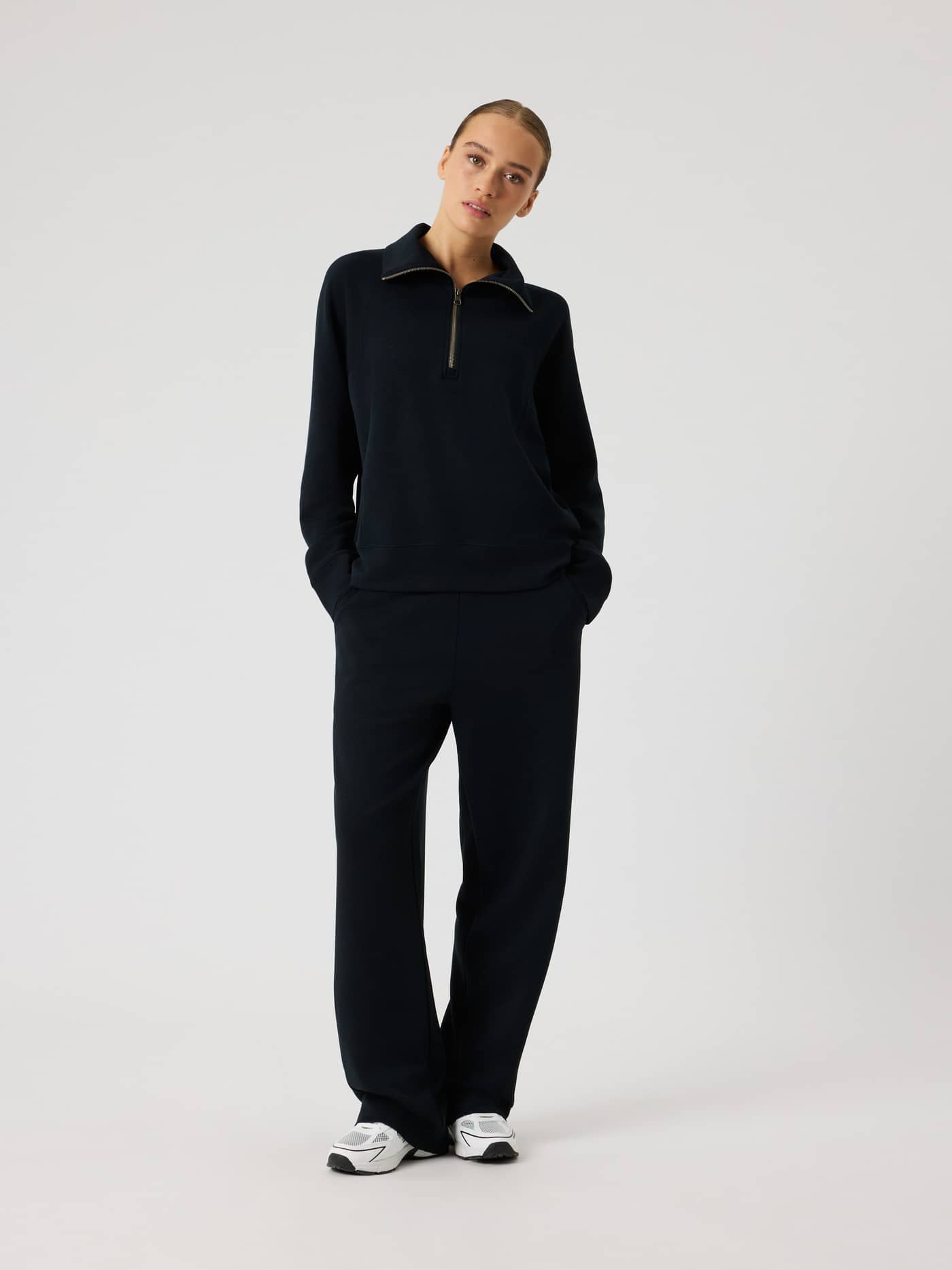 Full-body front view of a woman wearing the loose fit Studio Soft Halfzip Sweatshirt in Black Beauty (Black). - Image 3