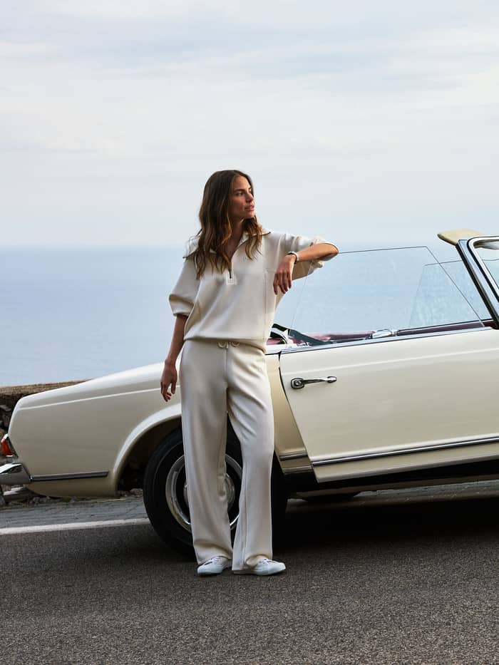 Studio Soft Halfzip Sweatshirt in Tofu (White) with a stylish loose fit, worn by a woman next to a vintage car.