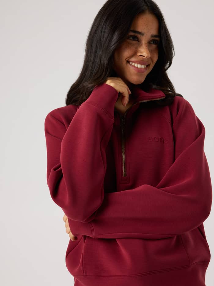 Close-up of the Studio Soft Halfzip Sweatshirt in Cabernet (Red) highlighting the high collar and half-zip closure.