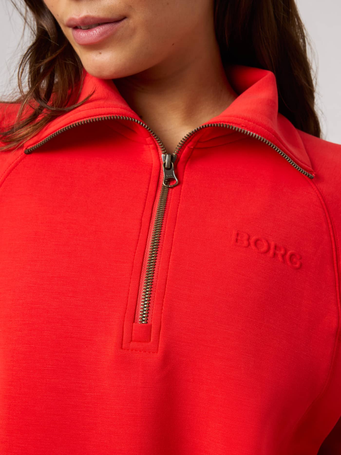 Close-up of the Flame Scarlet (Red) Studio Soft Halfzip Sweatshirt with a high collar, half-zip, and tonal Borg logo. - Image 7