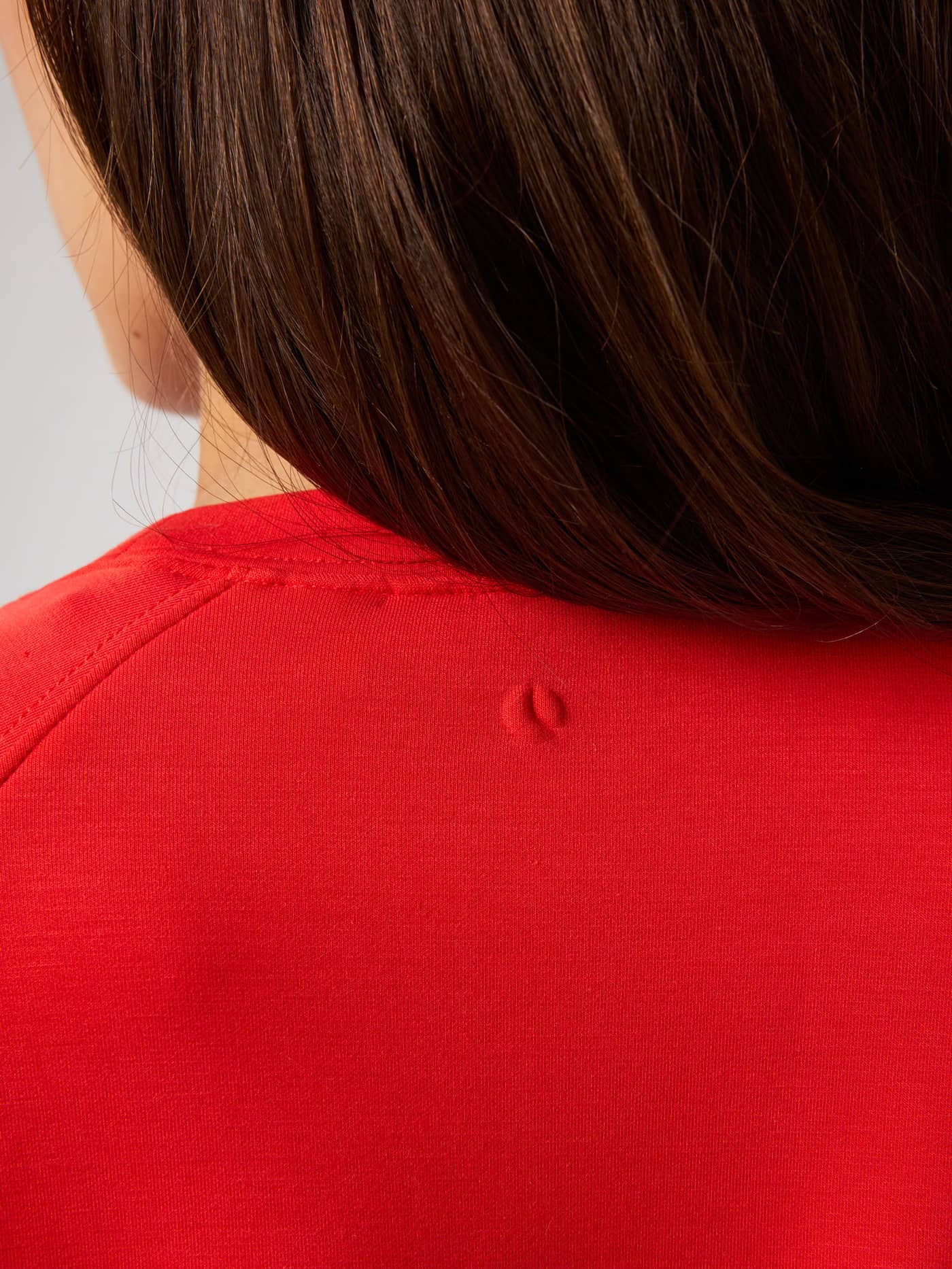 Back neck detail of the Studio Soft Sweatshirt in Flame Scarlet (Red) featuring a tonal tennis ball logo. - Image 5