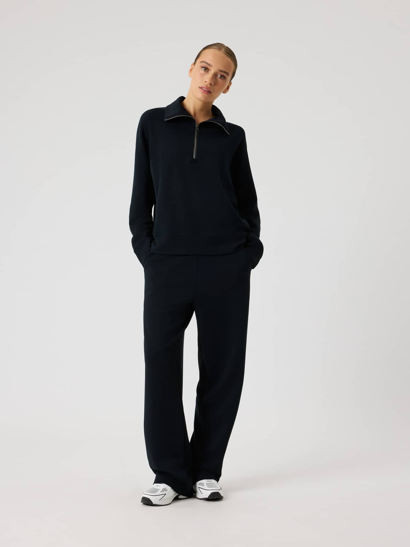 Full-body front view of a woman wearing the stylish Studio Soft Sweatpants in Black Beauty (Black) for a comfortable fit. - Image 3