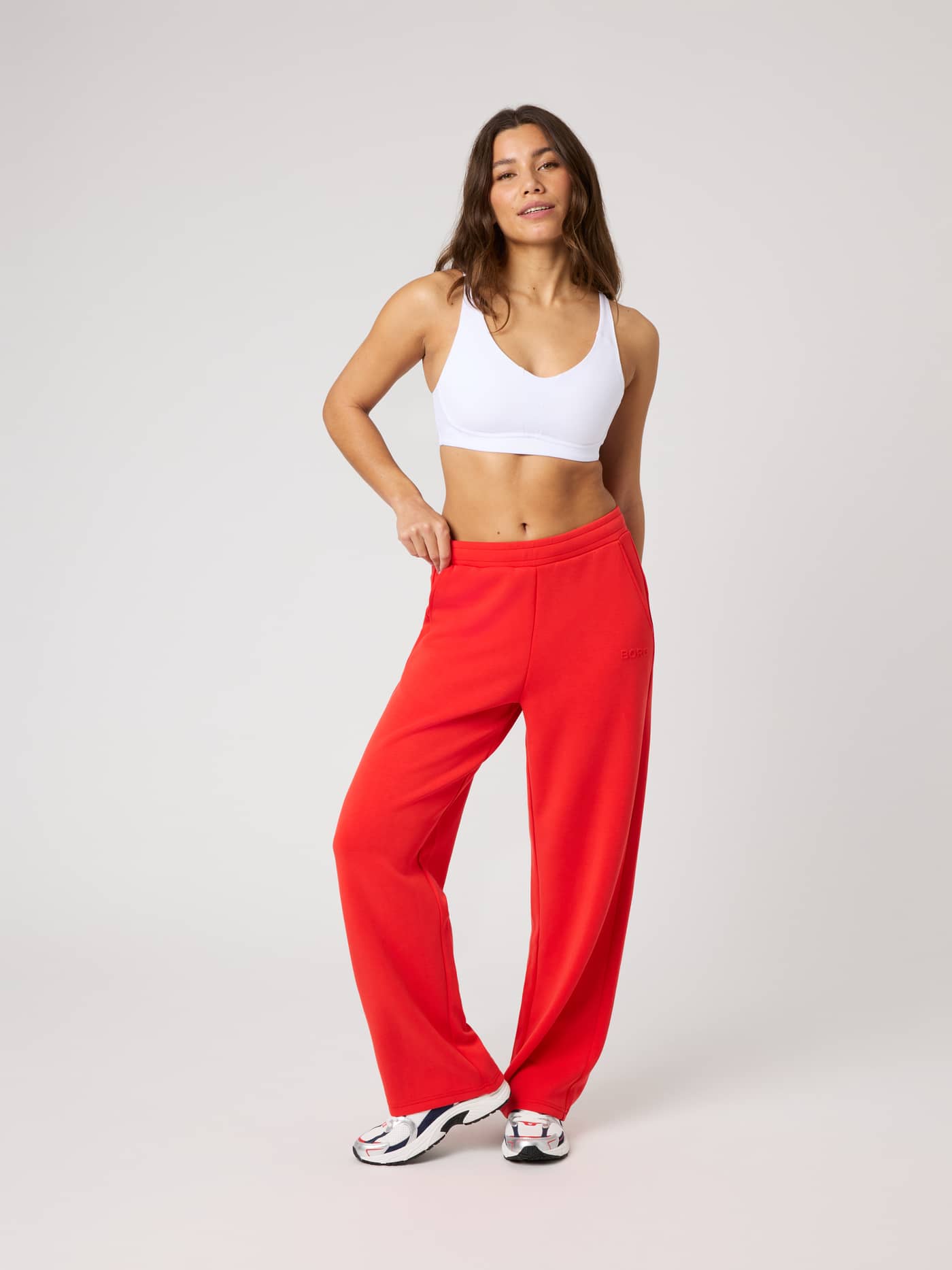 Full-body front view of a model wearing Studio Soft Sweatpants in Flame Scarlet (Red) with a comfortable, loose fit. - Image 2