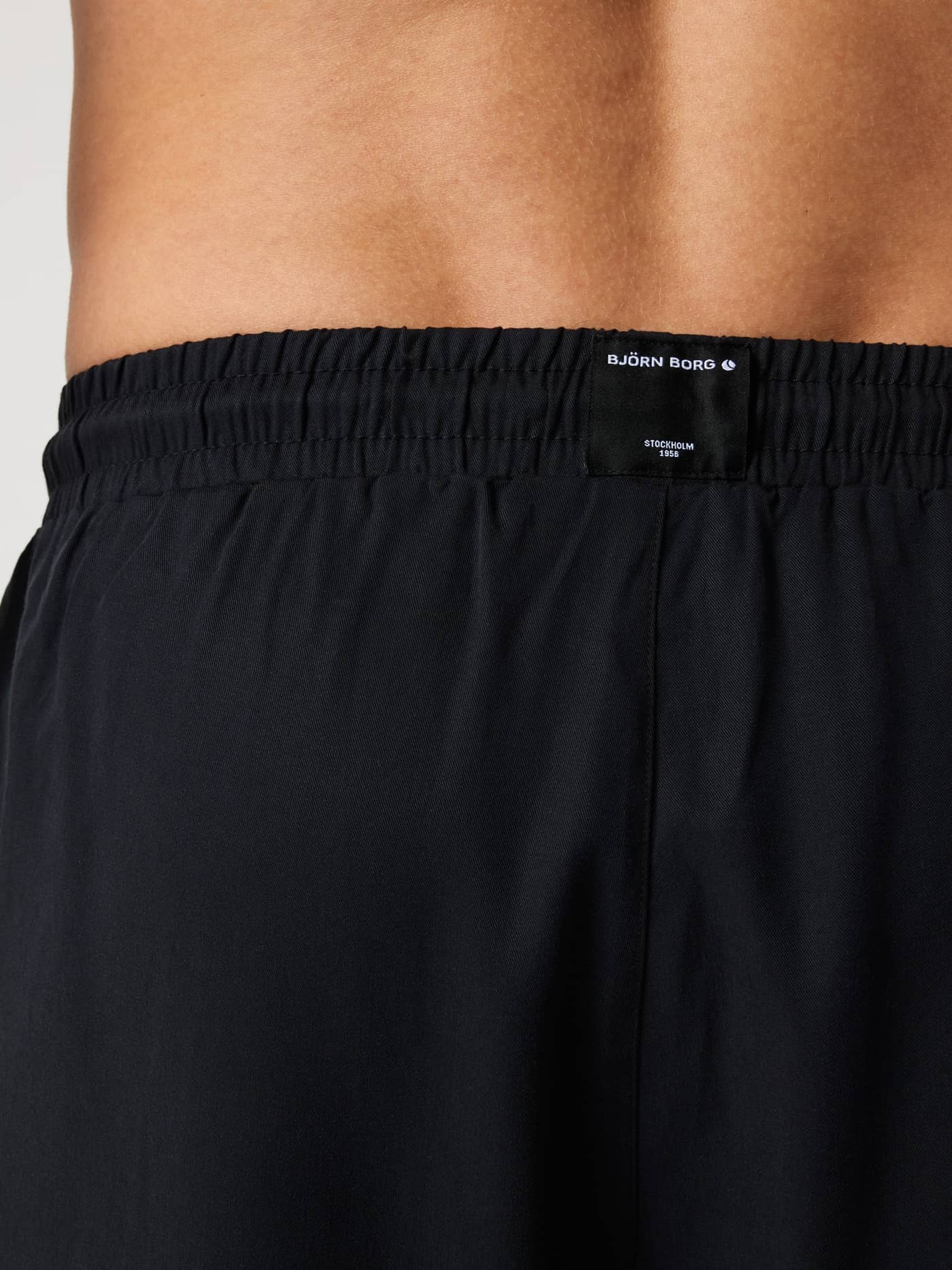 Gros plan de dos du Borg Lyocell Resort Shorts en Black Beauty (Noir), soulignant l'étiquette logo à la taille. - Image 3