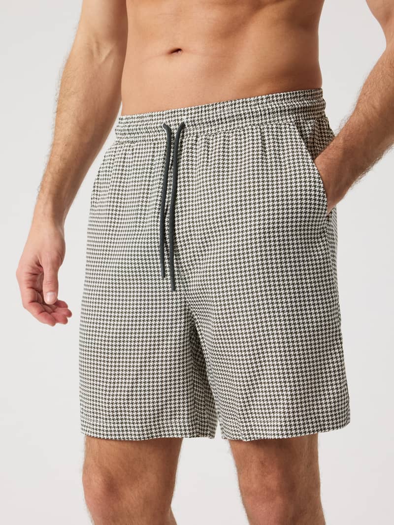 Front view of a man wearing the Borg Lyocell Resort Shorts in Houndstooth 3 (Black, White) made from soft lyocell.