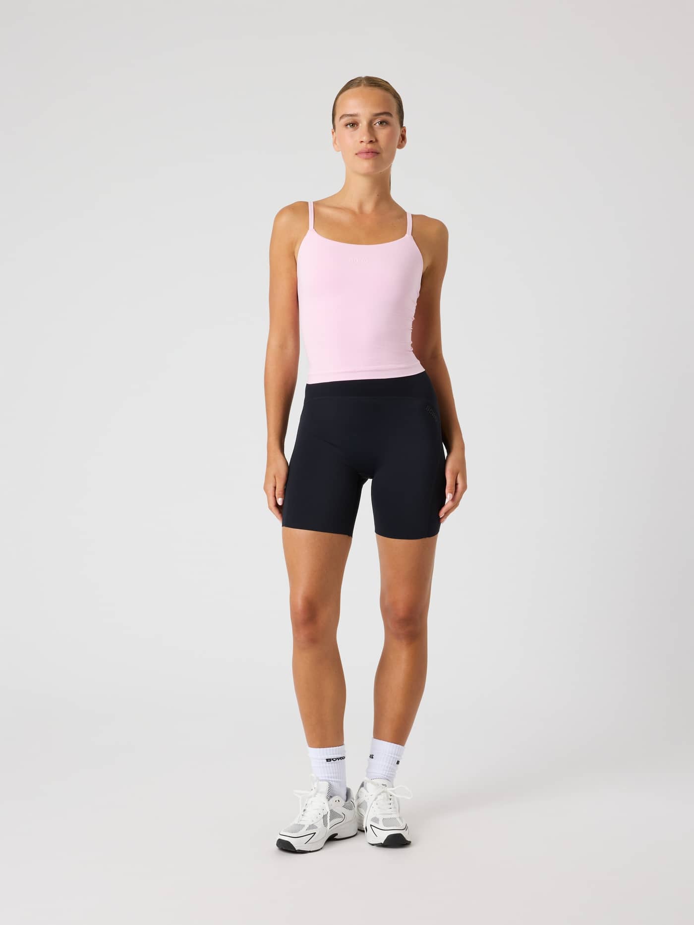 Full-body front view of a woman in the Pink Lady (Pink) Studio Soft Cropped Tank Top, featuring a slim fit for training. - Image 5