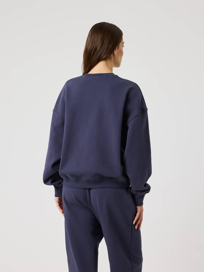Rückansicht eines Models im Björn Borg Studio Oversized Sweatshirt in Odyssey Gray (Marineblau) mit entspannter Passform. - Image 3