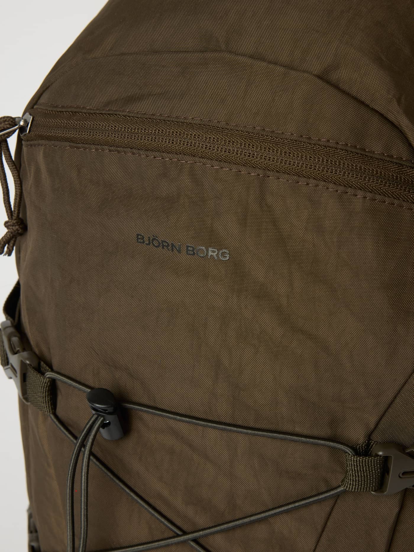 Close-up of the Falcon (Brown) Borg Explorer Backpack 28L for training, showing the grey logo and front zipper. - Image 5