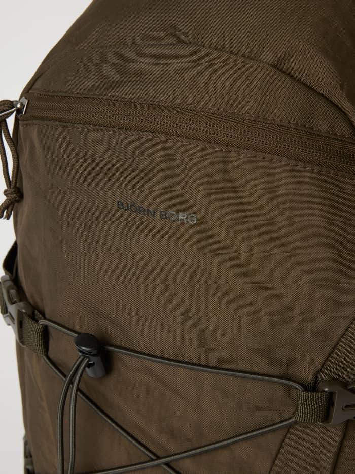 Close-up of the Falcon (Brown) Borg Explorer Backpack 28L for training, showing the grey logo and front zipper. - Image 5
