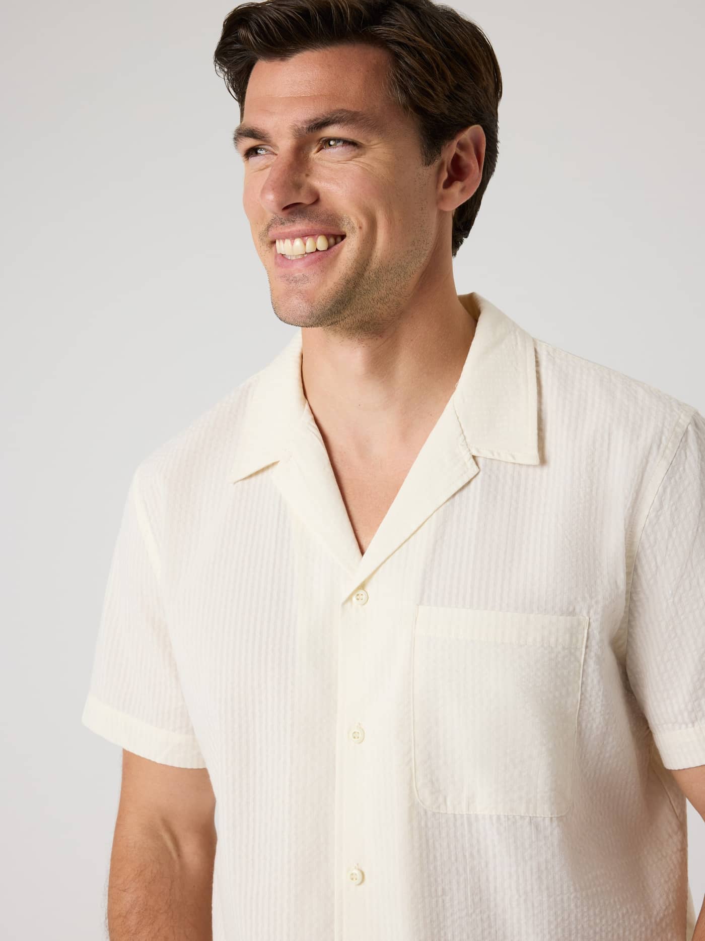 Front view of a man wearing the Borg Seersucker Resort Shirt in Tofu (White) with a camp collar and chest pocket. - Image 4