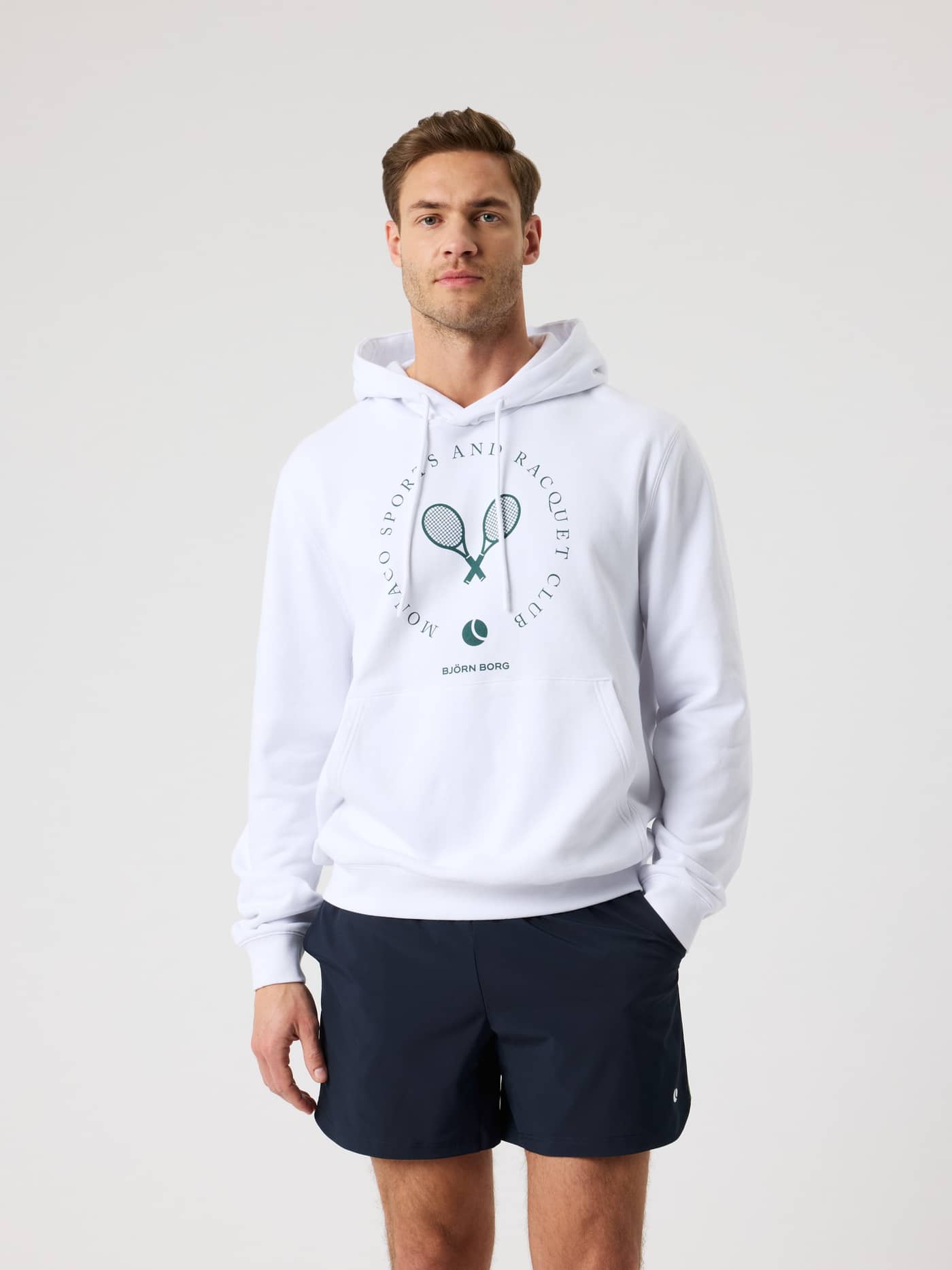 Front view of a man wearing the Borg Classic Print Hoodie in Brilliant White (White) with a green tennis chest graphic. - Image 2