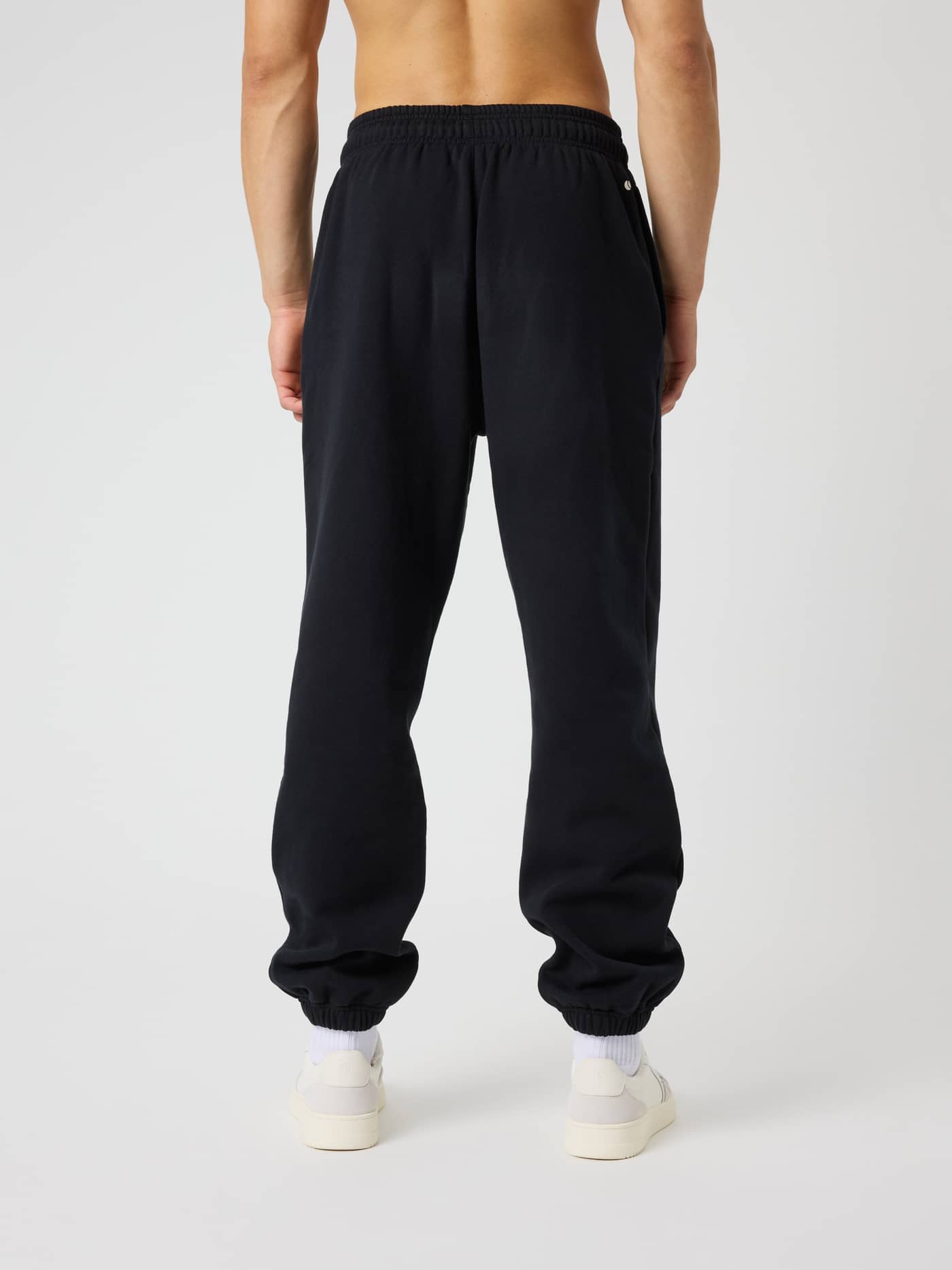 Back view of the Borg Oversized Sweatpants in Black Beauty (Black) featuring a relaxed fit and tennis-inspired print. - Image 2