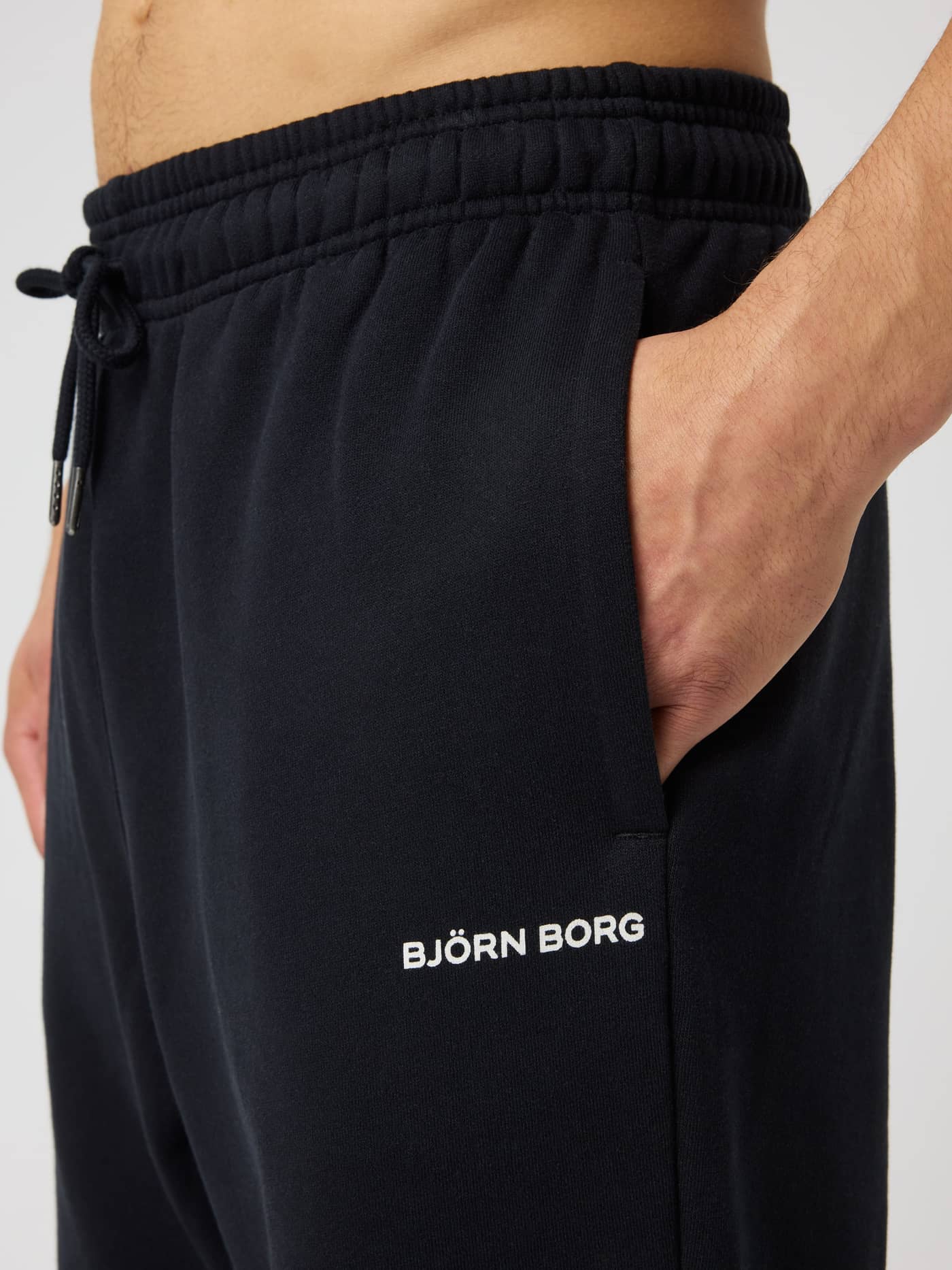 Borg Oversized Sweatpants in Black Beauty (Black) featuring a side pocket and white logo, designed for tennis recovery. - Image 4