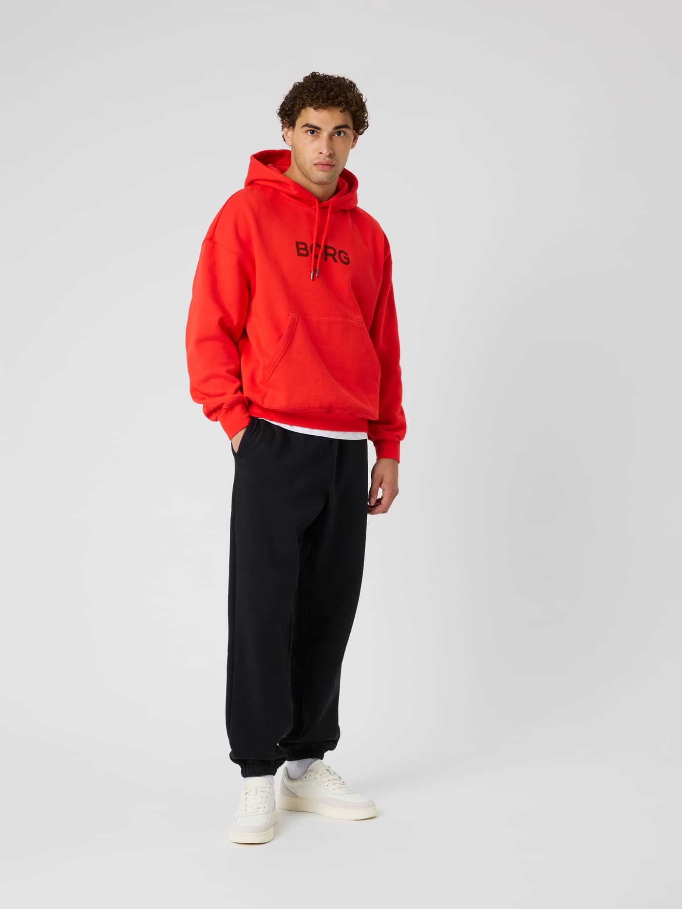 Full-body front view of a man wearing Borg Oversized Sweatpants in Black Beauty (Black) with a relaxed fit for tennis. - Image 3