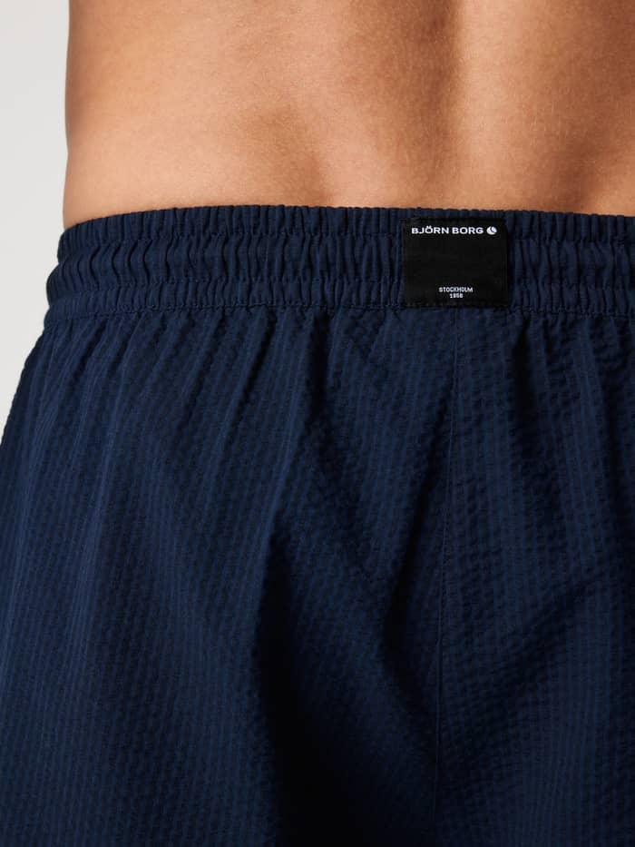 Close-up achterzijde van de Borg Seersucker Resort Shorts in Night sky (Marineblauw) met seersucker-textuur en merklabel. - Image 3